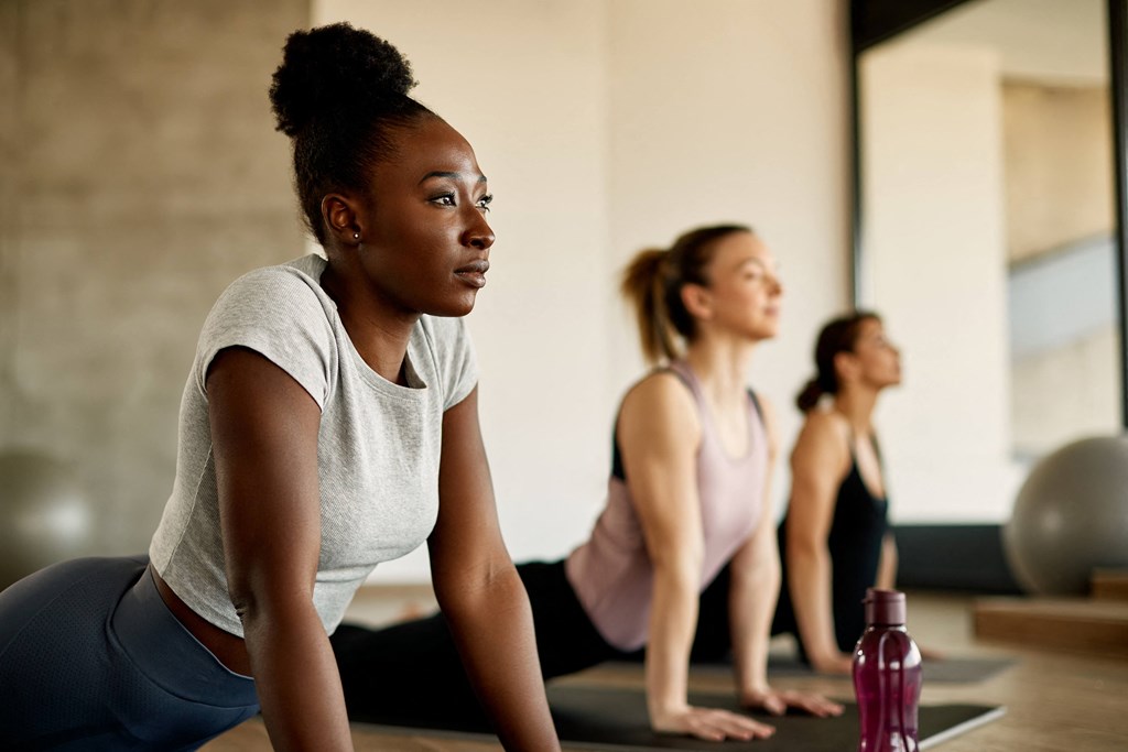 a group of women doing yoga in a gym