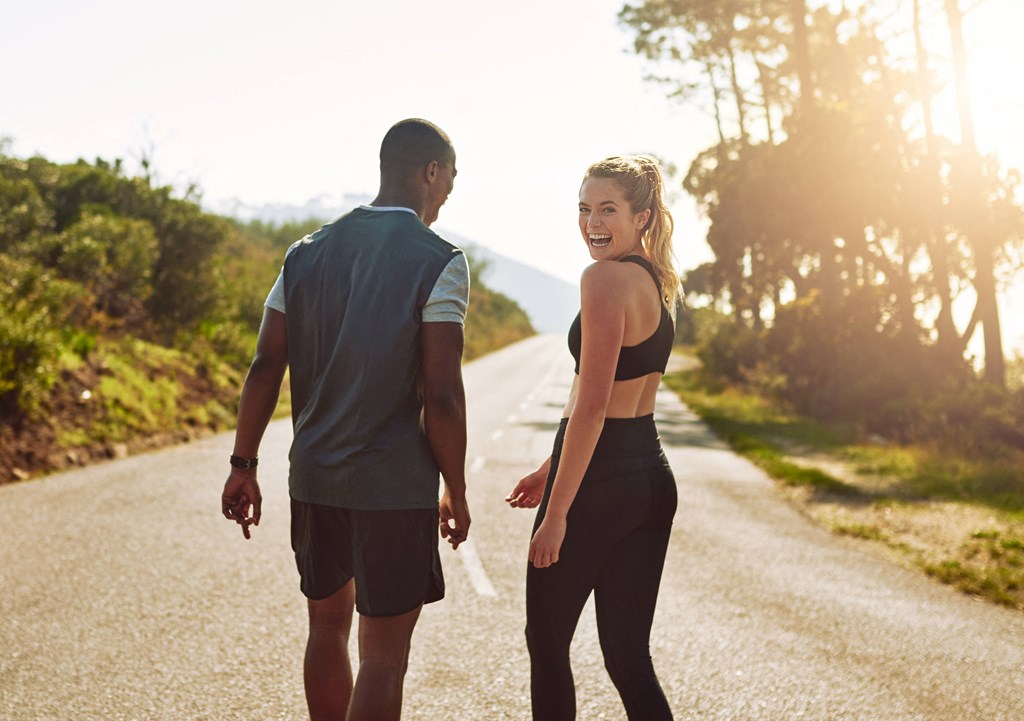 a man and a woman walking down a road