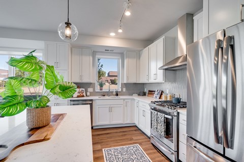 a kitchen with stainless steel appliances and white cabinets