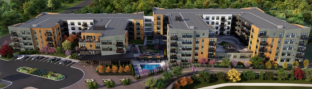 an aerial view of an apartment complex with a swimming pool and trees