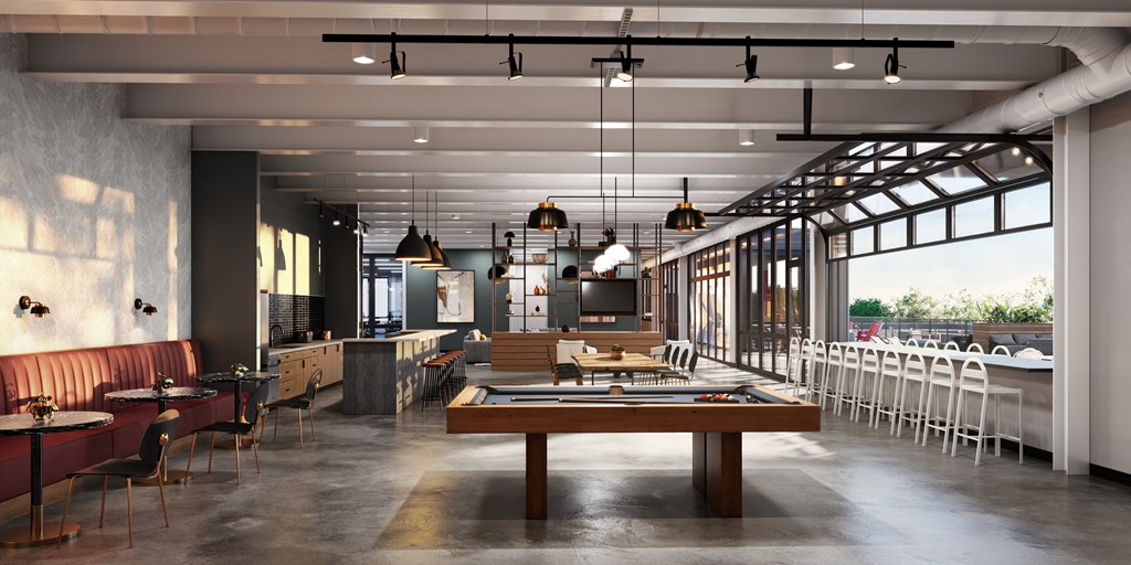 a large room with a pool table and tables in the middle