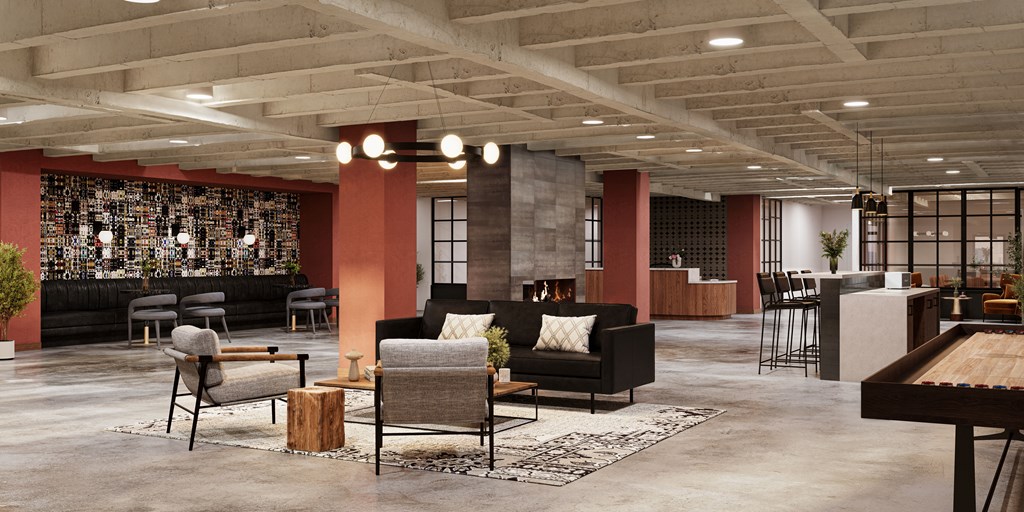 a lobby with couches chairs and tables and a bar