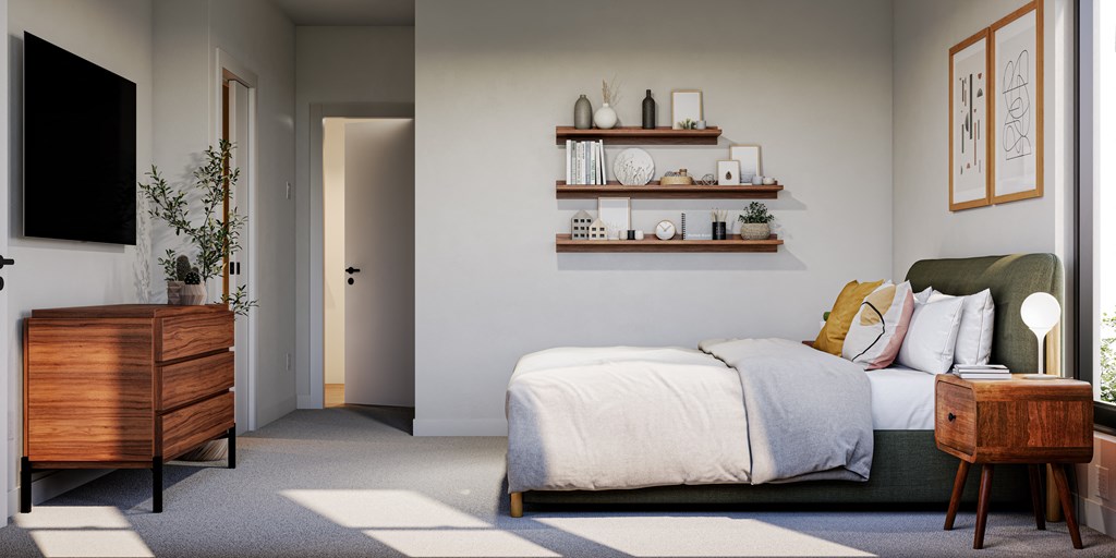 a bedroom with a bed and a dresser and a tv