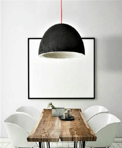 a dining room with a wooden table and a pendant lamp