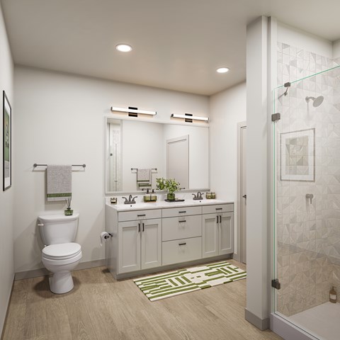 A white toilet sits in a bathroom next to a sink and mirror.