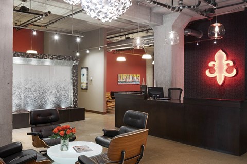A modern office space with a reception desk and chairs.