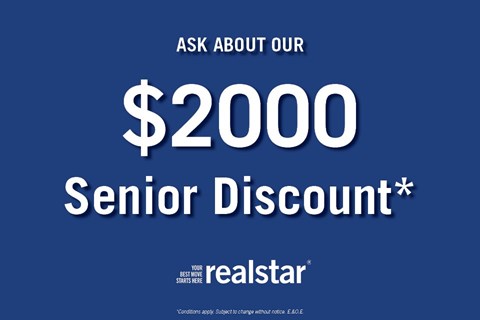 A blue advertisement for a $2000 senior discount from Realstar.