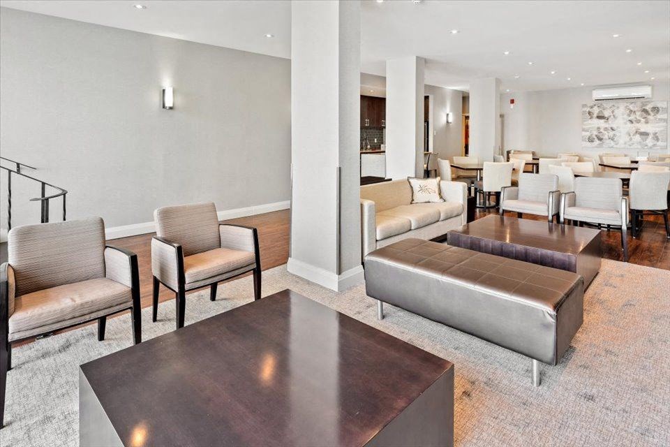 Social media with a living room with couches and chairs and a table at Victoria Place Apartments