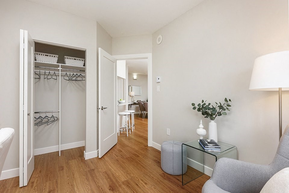 Bourg Du Village second bedroom showing closet with three clothing rods and shelving in Sainte Therese, QC