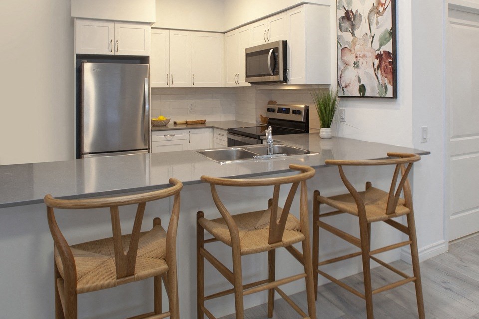 Kitchen with large built-in breakfast bar at Bayfield Tower Apartments in Barrie, ON