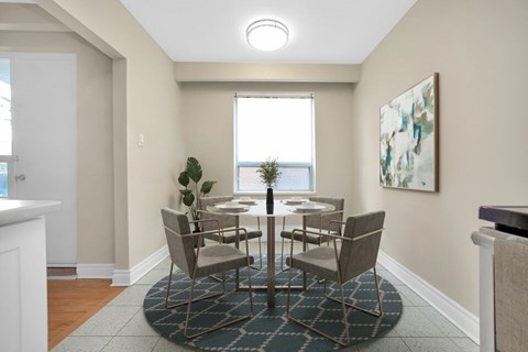 A dining room with a table set for six.