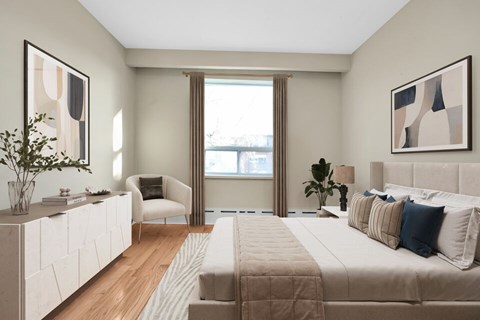 A bedroom with a large bed and a chair.