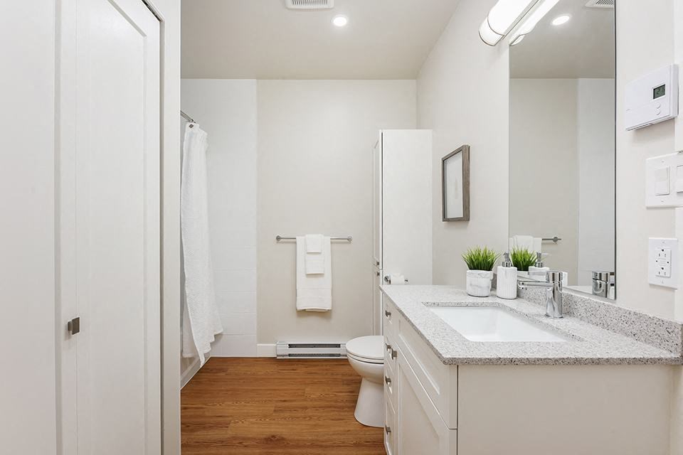 Bourg Du Village bathroom with tiled shower and tub and vanity with granite countertop Sainte Therese, QC
