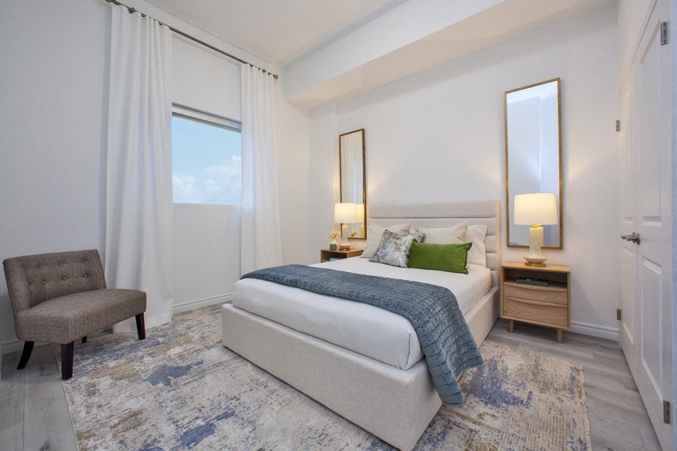Primary bedroom, with view towards window featuring custom blinds, at Bayfield Tower Apartments in Barrie, ON
