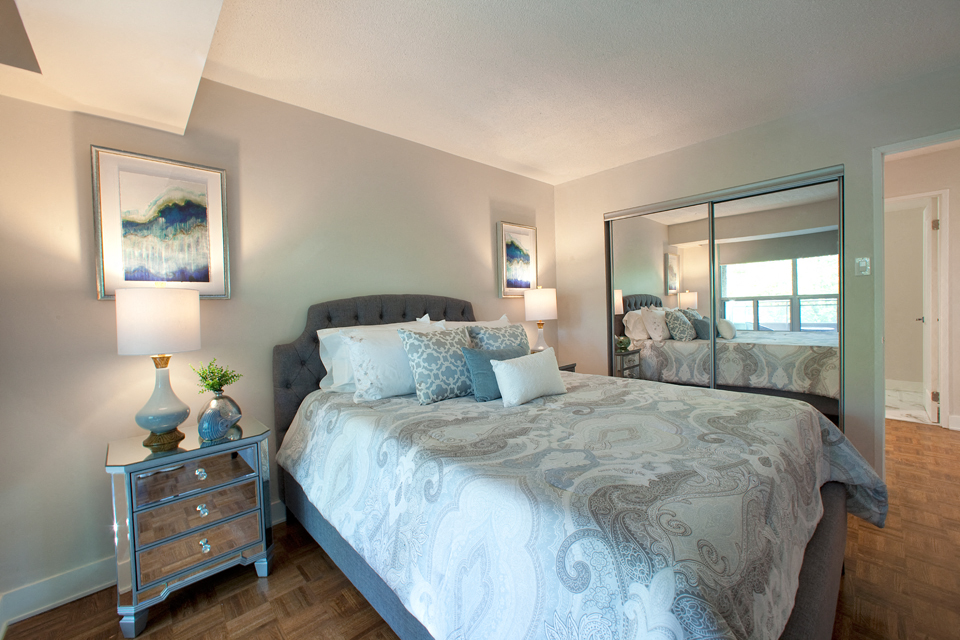 Brookbanks Quality bedrooms with large windows and blue accented furniture in Toronto, ON