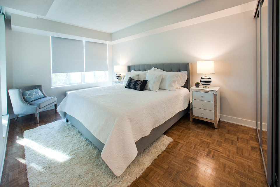Brookbanks Cozy bedroom with large windows and white covers on the bed in Toronto, ON