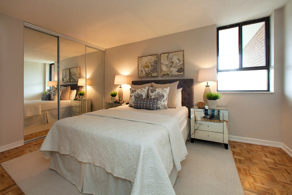 190 Cityview in Brampton, ON Bedroom with mirror door closet and two paintings above the bed