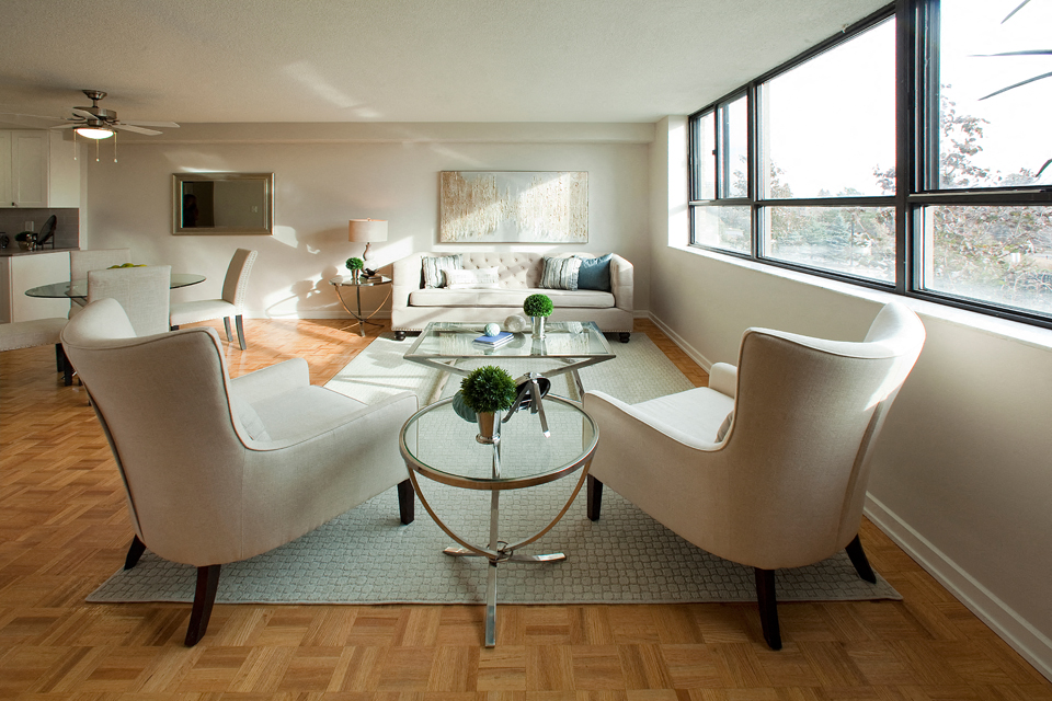 190 Cityview in Brampton, ON Modern living room with stylish white chairs and a glass table between them