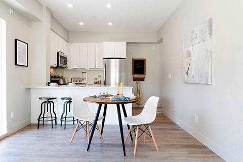 a kitchen and dining room with a table and chairs