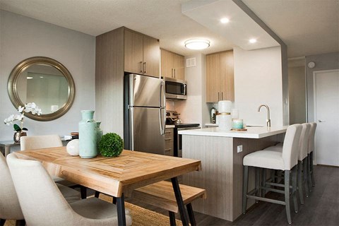 a kitchen and dining room with a table and chairs