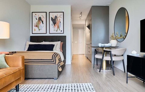 A modern bedroom with a large bed and a chair.