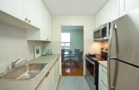 a kitchen with a sink and a refrigerator