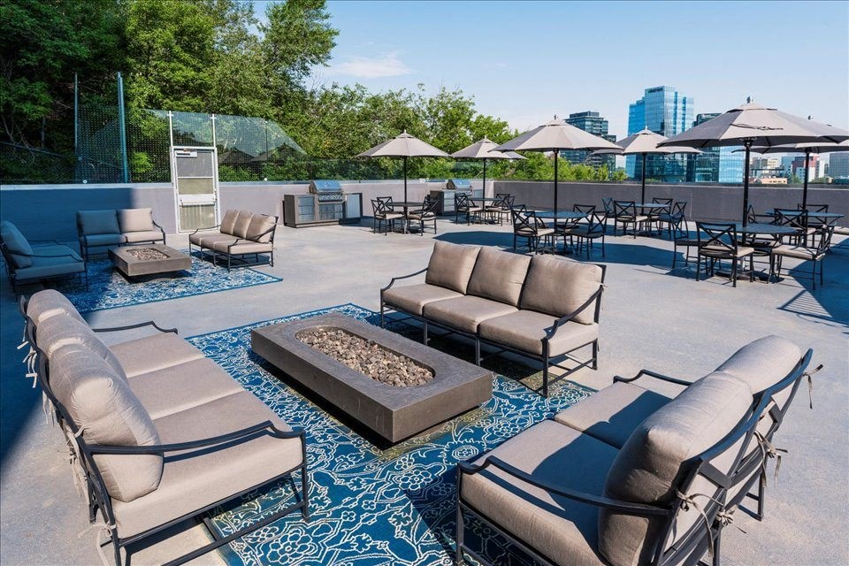 outdoor terrace with table and chairs at Victoria Place Apartments