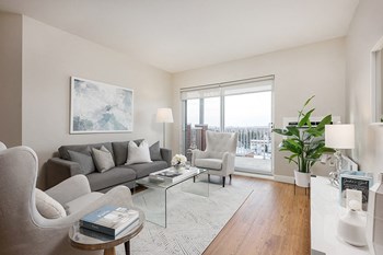 Bourg Du Village living room with sliding patio door leading to balcony in Sainte Therese, QC - Photo Gallery 3
