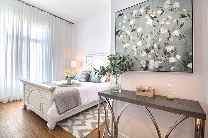 Spacious bedroom featuring luxury vinyl flooring at La Voile Broisbriand apartments in Broisbriand, Quebec
