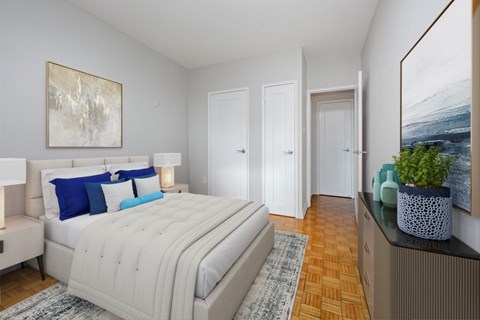 A bedroom with a large bed and a painting on the wall.
