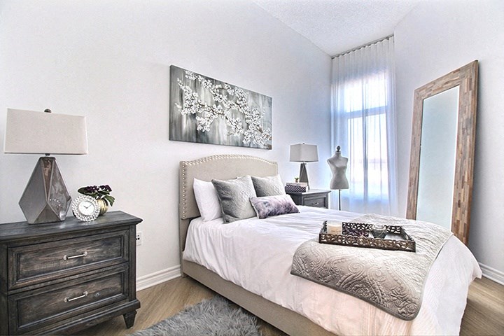 Brightly lit spacious bedroom at La Voile Broisbriand apartments in Broisbriand, Quebec