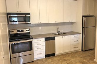 5062-5078 Dundas Street kitchen with upgraded modern cabinetry - Photo Gallery