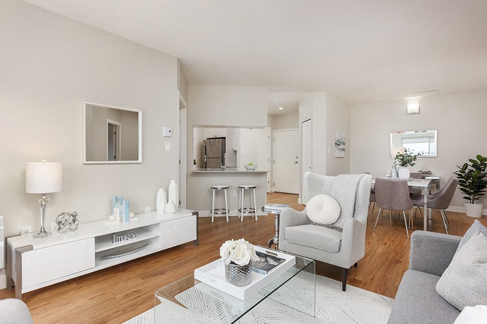 Bourg Du Village living room looking towards kitchen with breakfast bar in Sainte Therese, QC