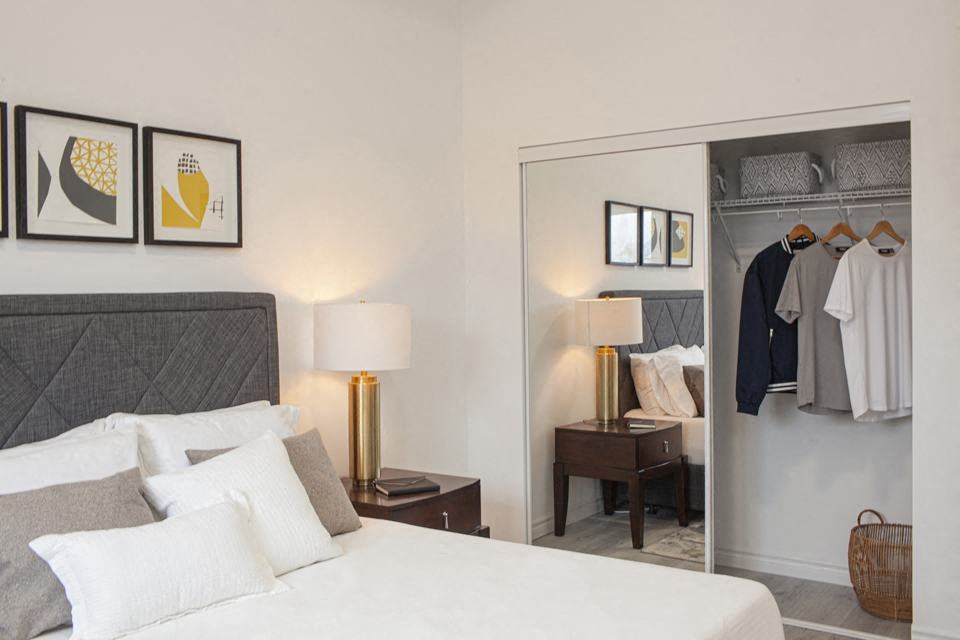 Bedroom showing closet with double sliding glass mirror doors in a one bedroom apartment at Bayfield Tower Apartments in Barrie, ON