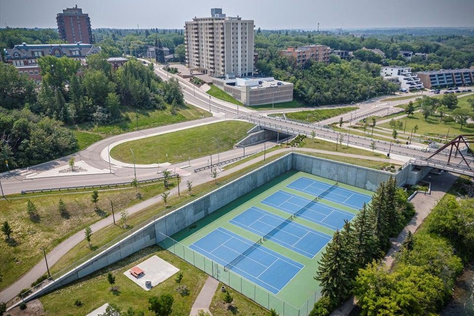 an aerial view of a tennis court in the city