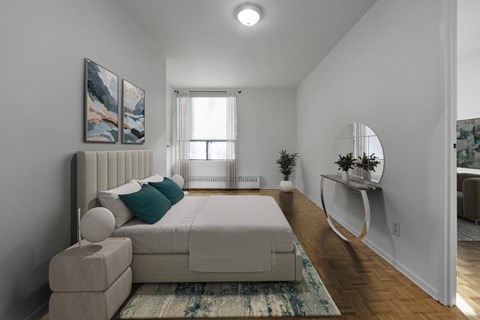 A bedroom with a large bed and a painting on the wall.