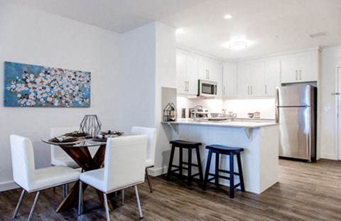 a kitchen and dining area with a table and chairs