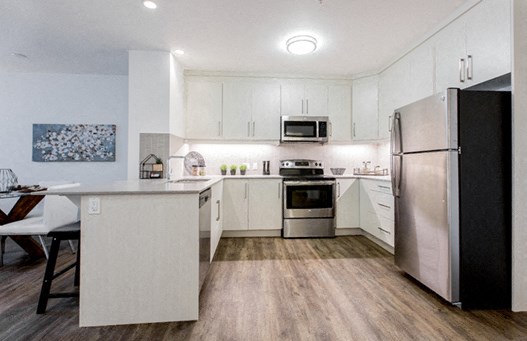 Kitchen with breakfast bar island at 99 Jasper in Edmonton, AB