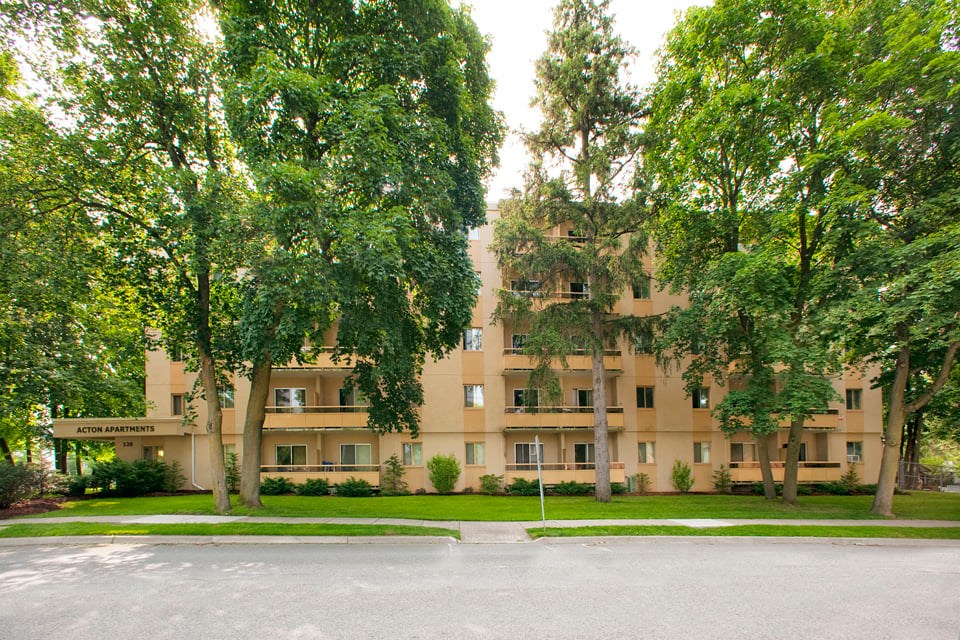 Acton Apartments exterior image of building surrounded by trees in Acton, ON