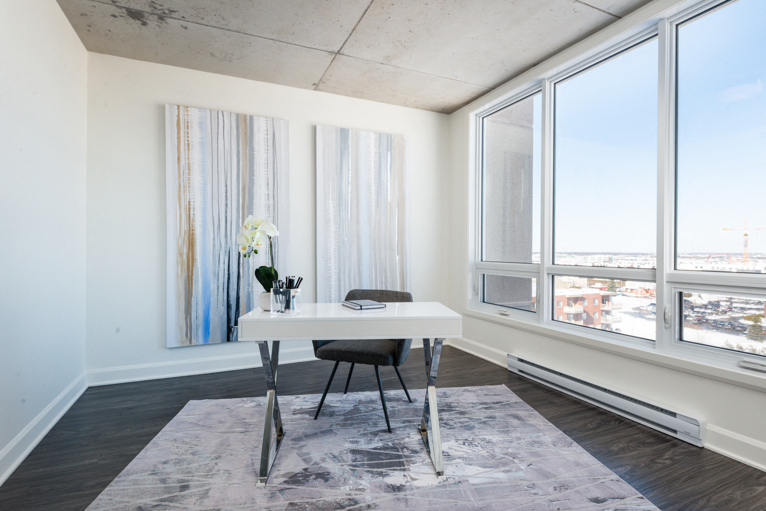 Home office with large windows at Axial Towers apartment in Laval, Quebec
