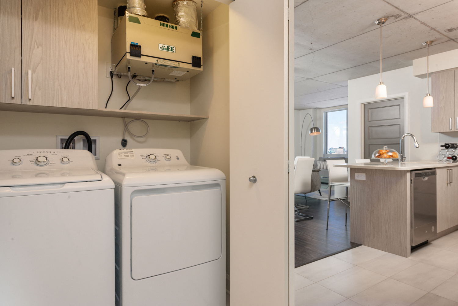 Convenient In-suite laundry with washer and dryer at Axial Towers apartment in Laval, Quebec