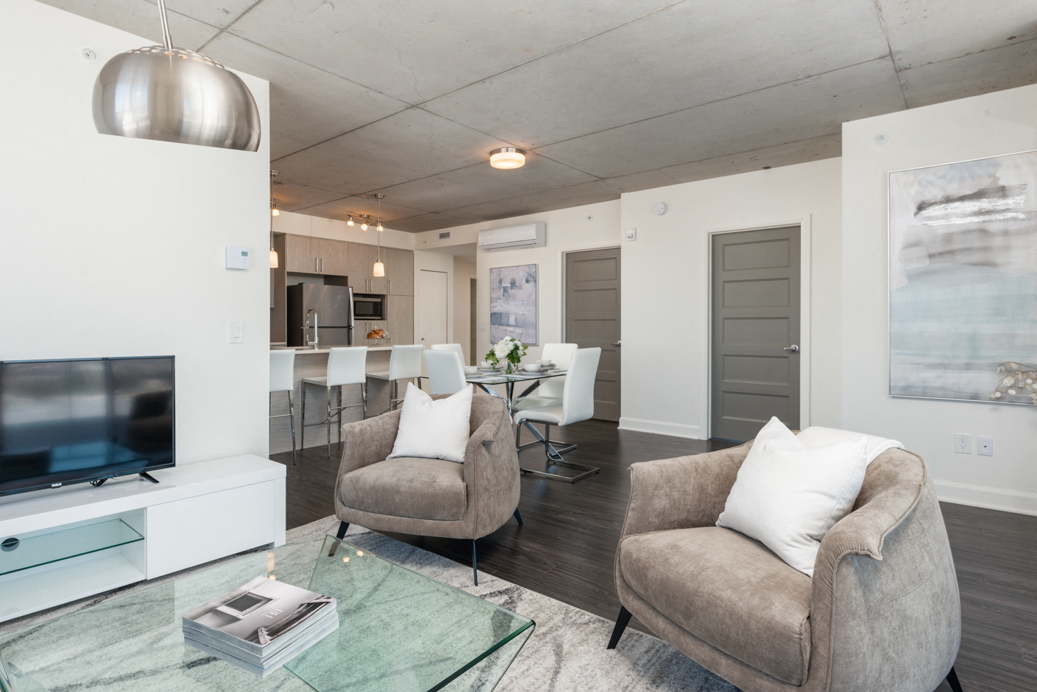 Open concept living room with premium finishes at Axial Towers apartments in Laval, Quebec