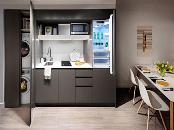 The Duke in Vancouver, BC Kitchen with in-suite laundry unit - Photo Gallery 4