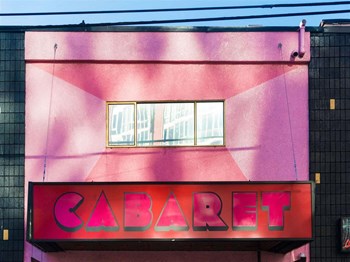 Pink building with sign that reads cab - Photo Gallery 66