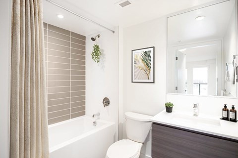 A bathroom with a white tub, toilet, and sink at 388 Kaslo East Village.