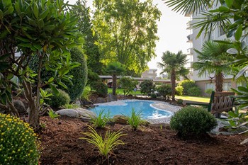 Bayview Gardens Apartments outdoor pool featuring bench seating and landscaping in White Rock, BC - Photo Gallery 14