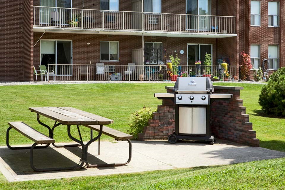 Shared outdoor seating and BBQ area at Bayview Towers in Sarnia, ON
