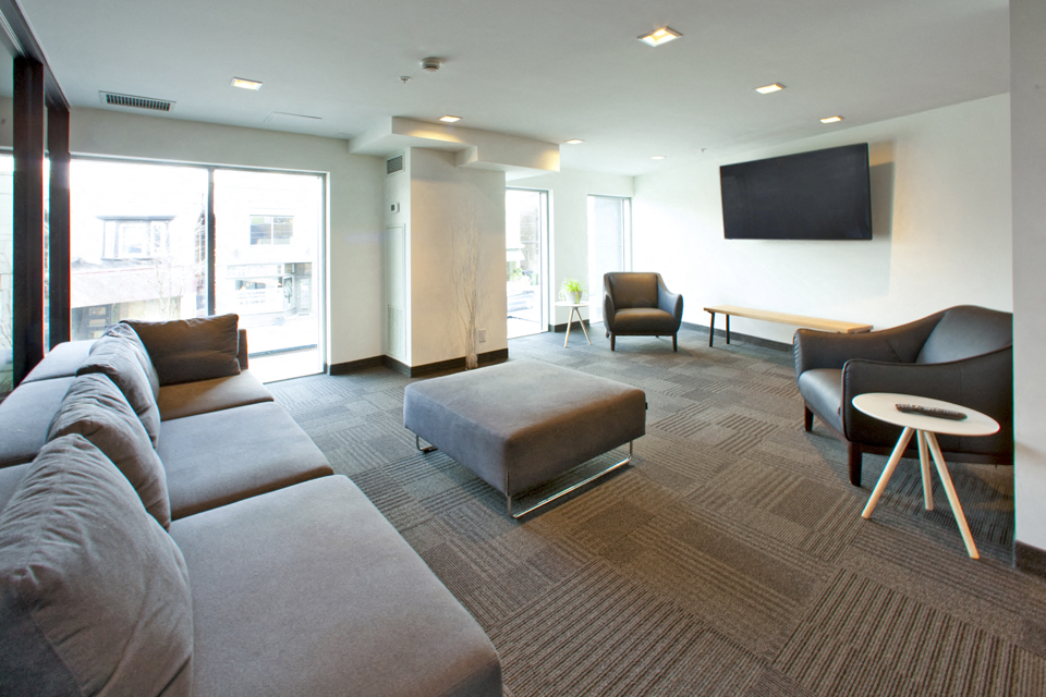 BeachHill Apartments lounge area featuring sofa seating and flat screen TV in Toronto, ON
