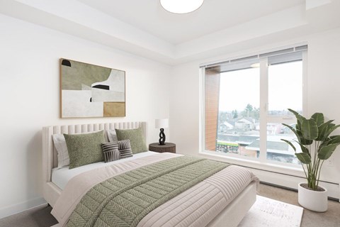 A bedroom with a large bed and a painting on the wall at 388 Kaslo East Village.