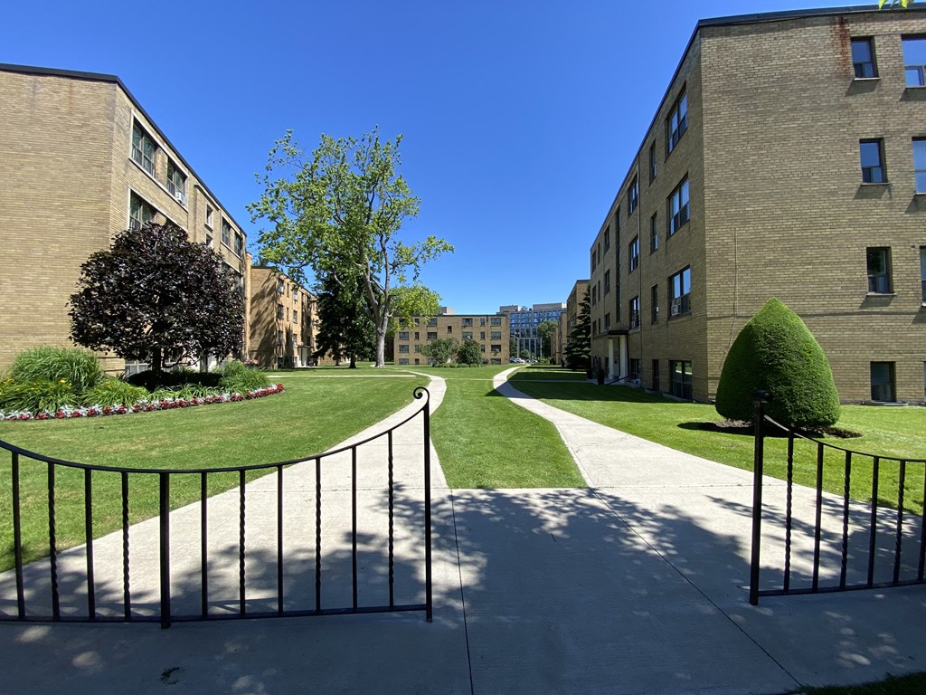 pathway towards the buildings at Bexhill Court Apartments in Toronto Ontario